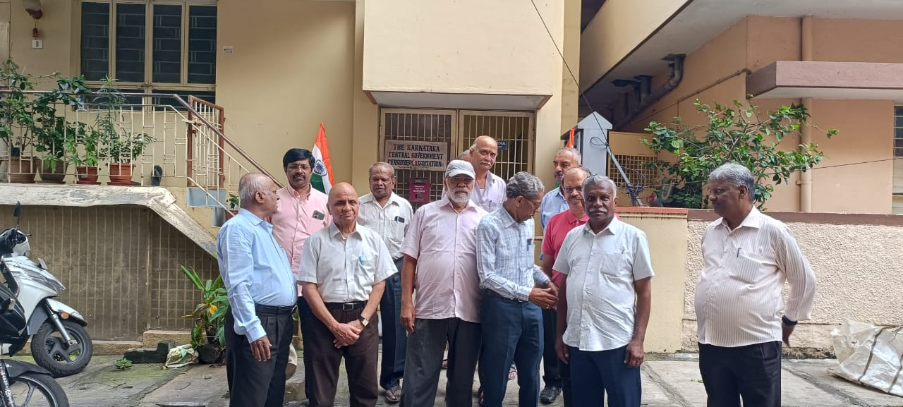 Members gathered with the national flag outside the Association office